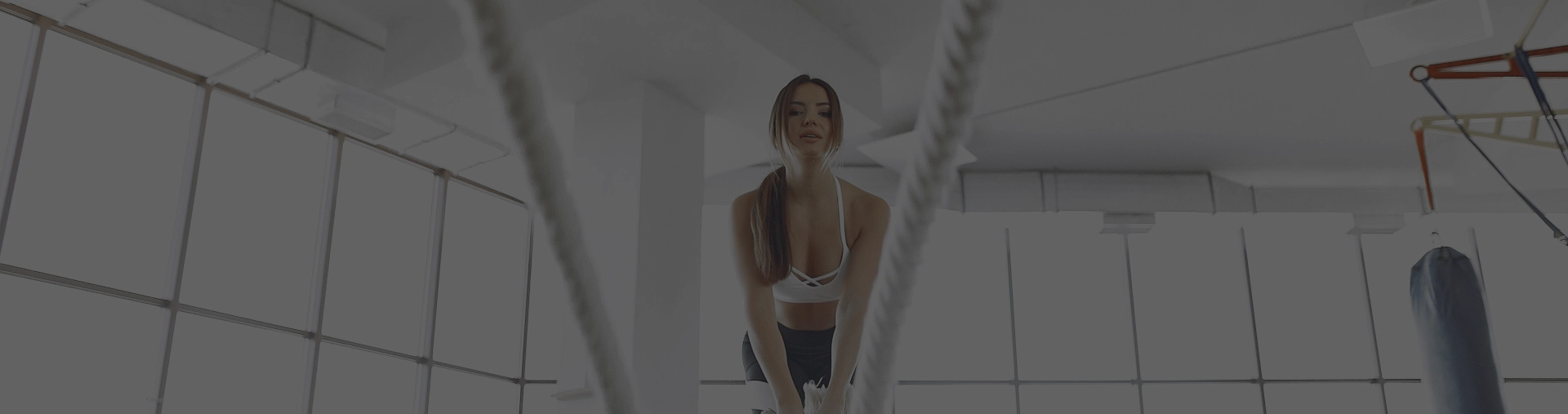 Sporty attractive woman training in a morning gym.