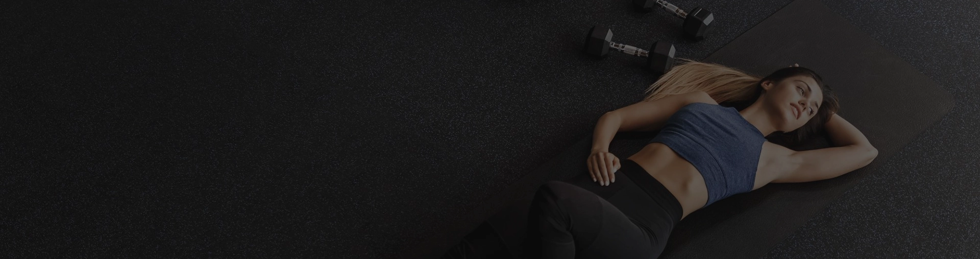 Sporty attractive woman training in a morning gym.